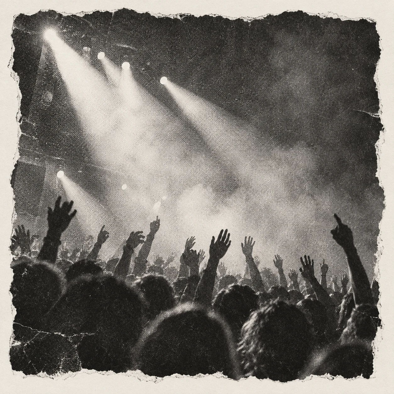 Black and white photo of a crowd reaching toward stage lights through smoke