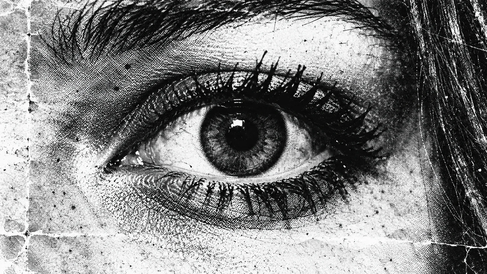 Black and white photocopy close-up of a single wide-open eye